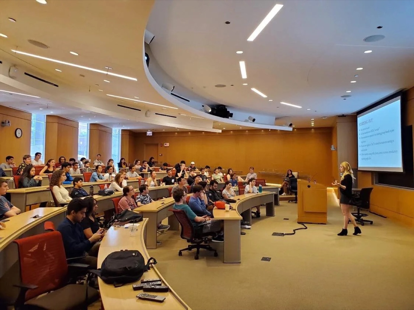 A packed college lecture hall at a debate club intro night