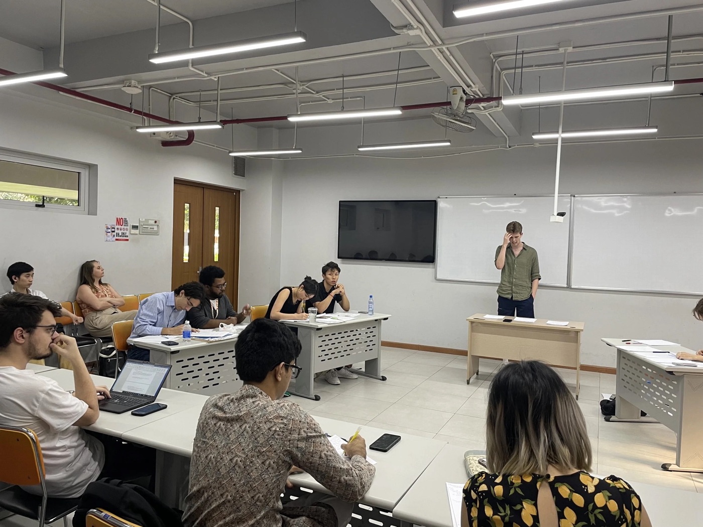 A parliamentary practice round in a classroom, one debater mid-speech